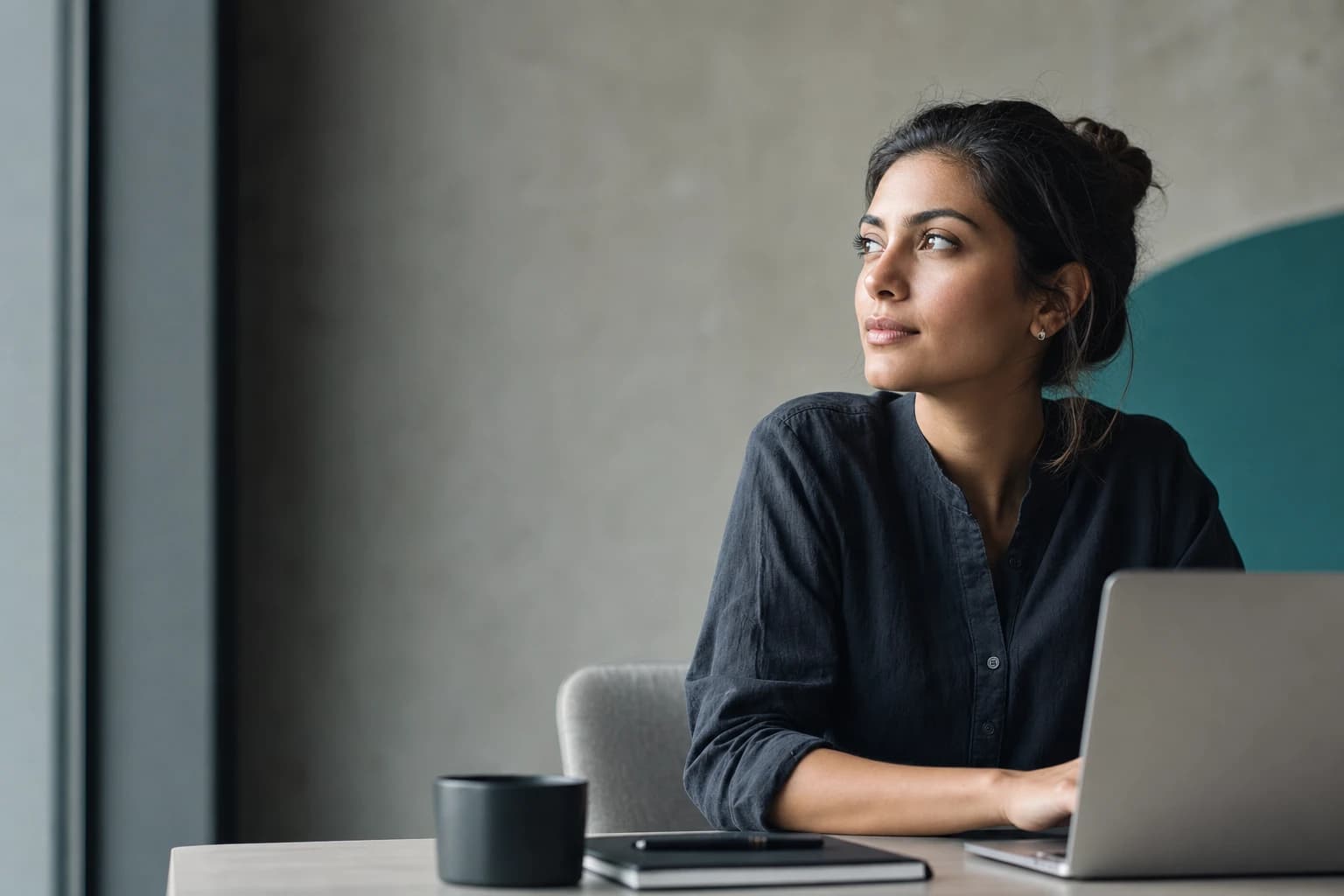 A growth marketer thinking through a content workflow in a quiet workspace